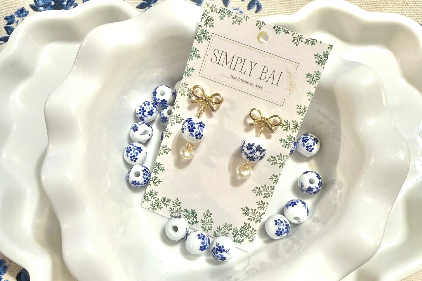The Daphne | Blue and white floral bead Earrings with gold bow accent